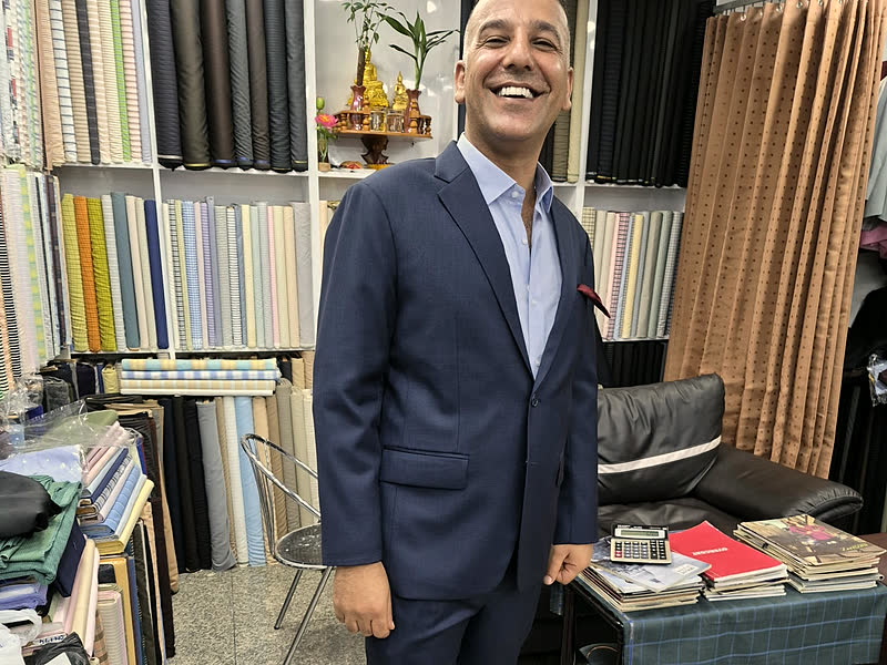 A guest in a navy two-piece suit in the shop