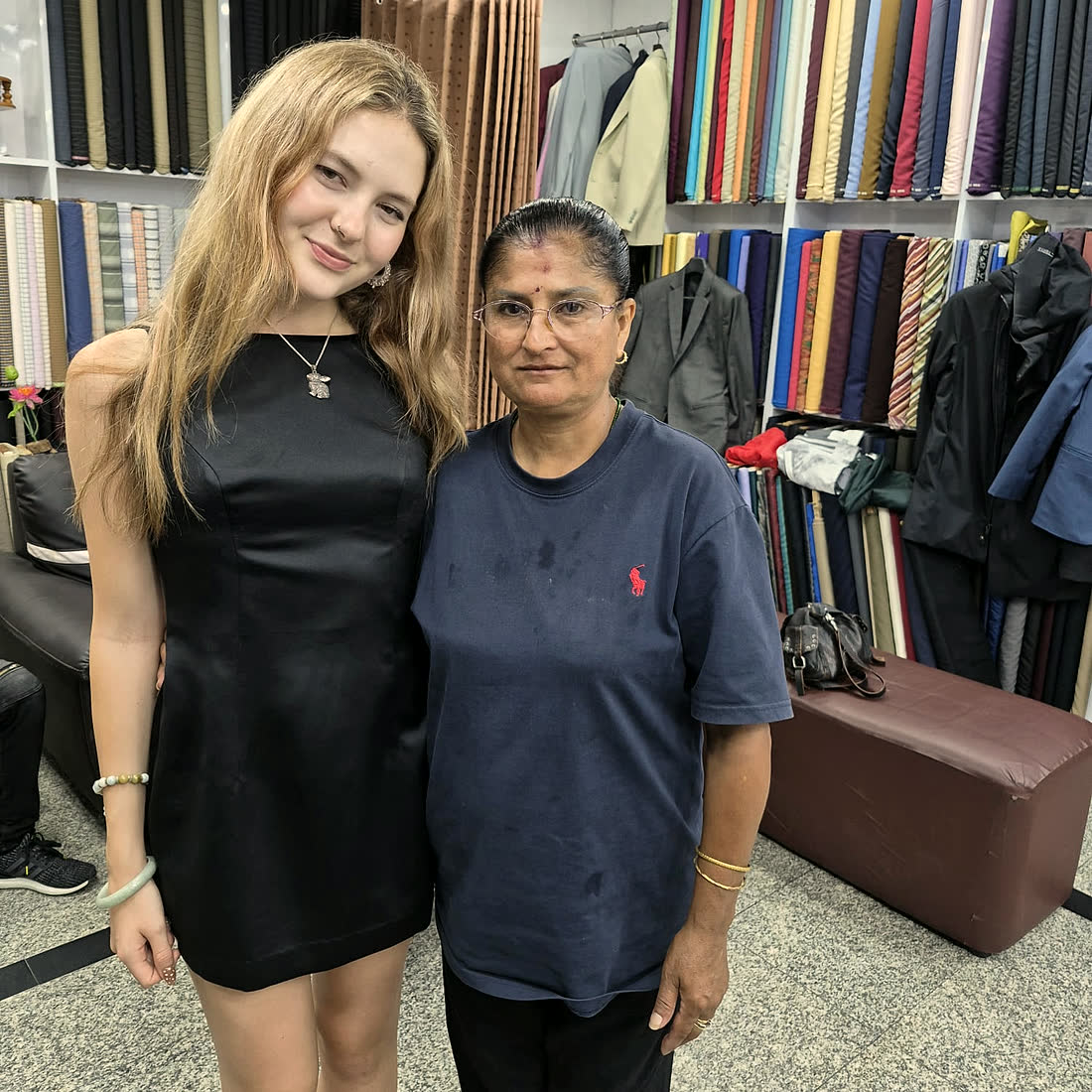 A guest and one of the tailors together in the shop