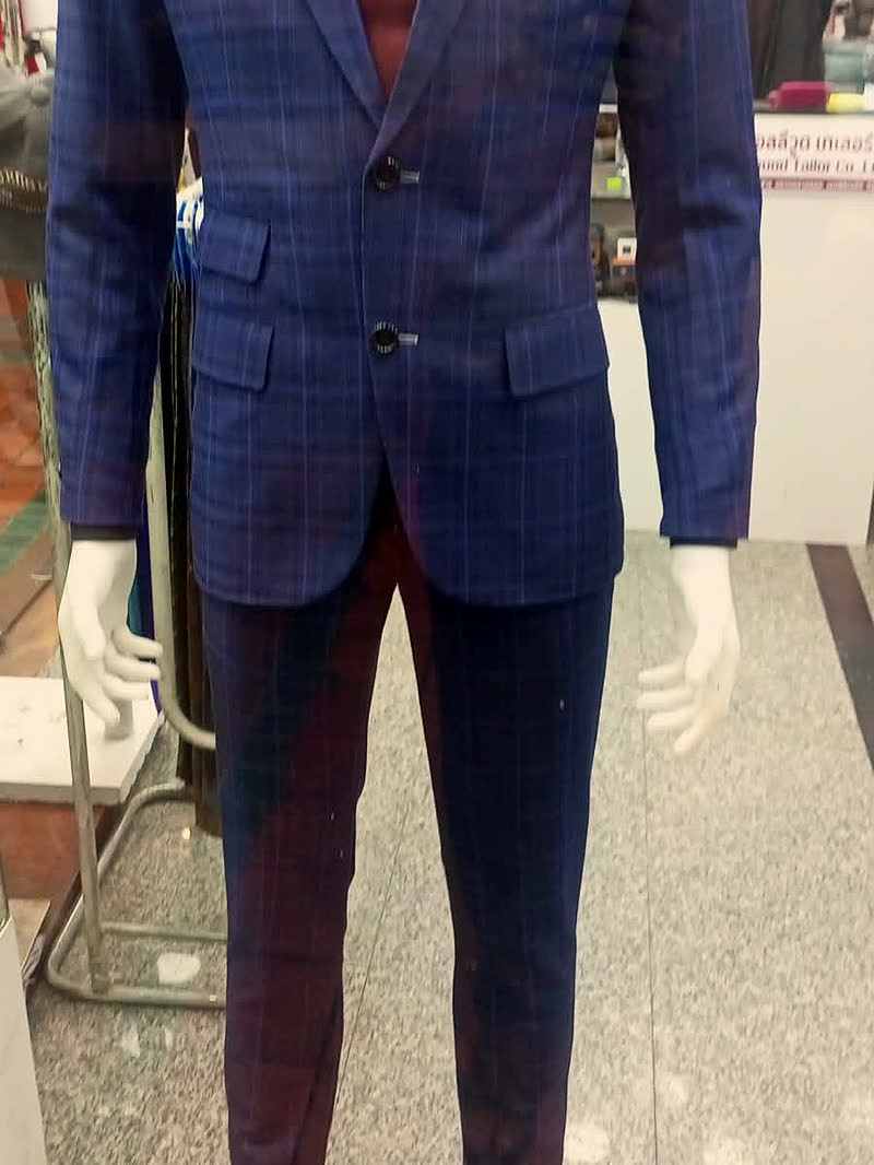 A checked suit on the shop's own mannequin