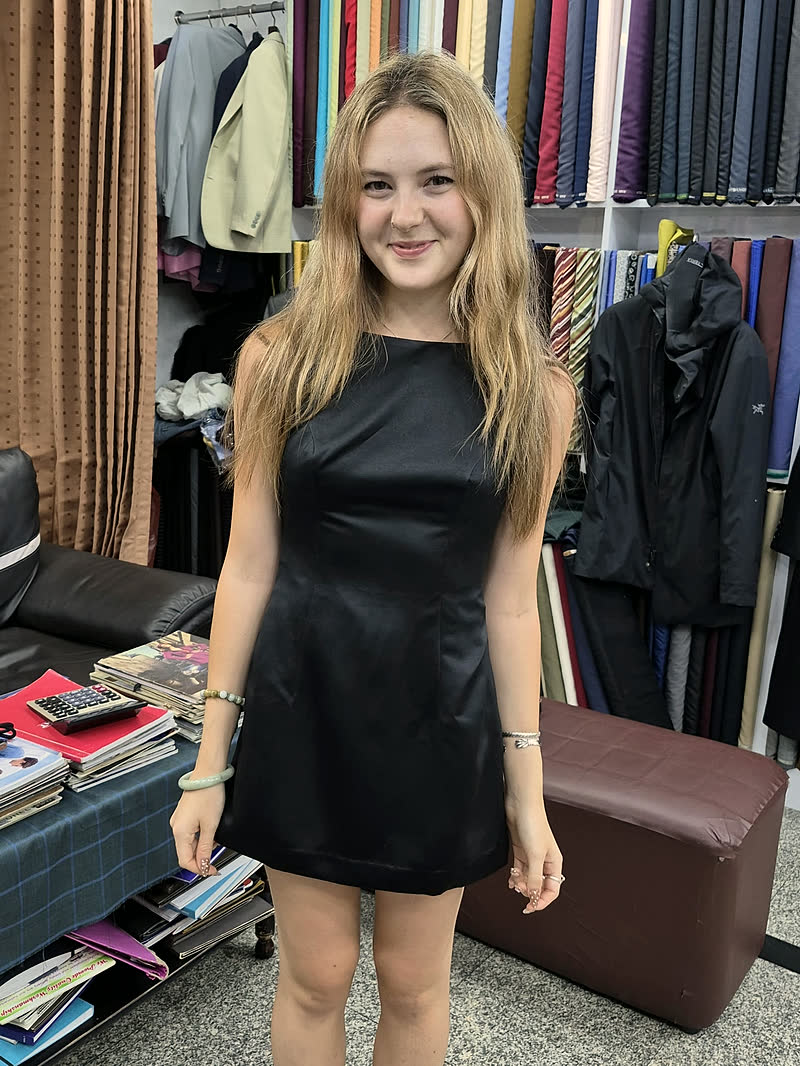 A guest in a made-to-measure black dress